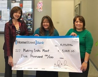 Staff of Making Ends Meet holding the award check